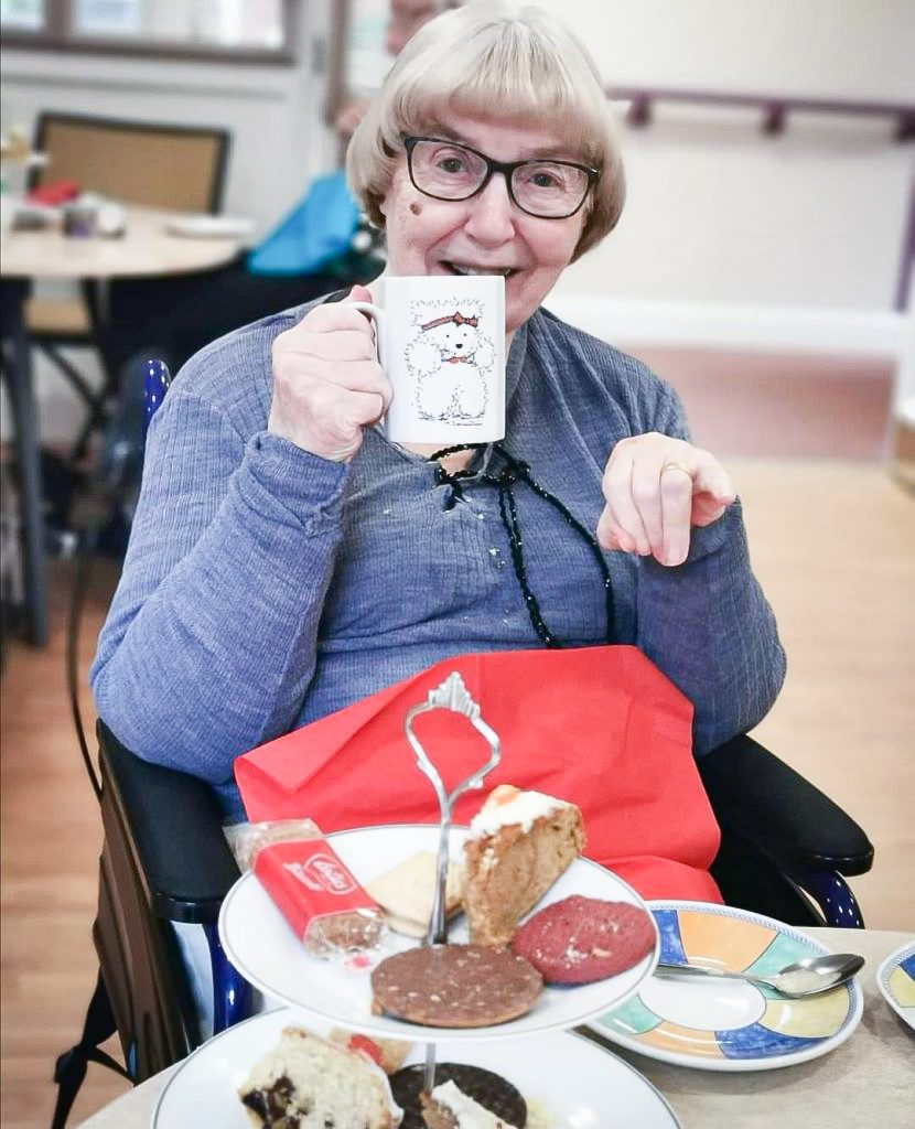 resident enjoying tea at the cafe in Woking that welcomes older people and the local community