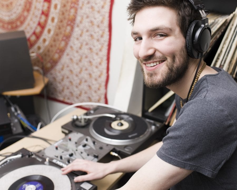 Caucasian Young Man DJ in Music Studio Wearing Headphones, Copyspace