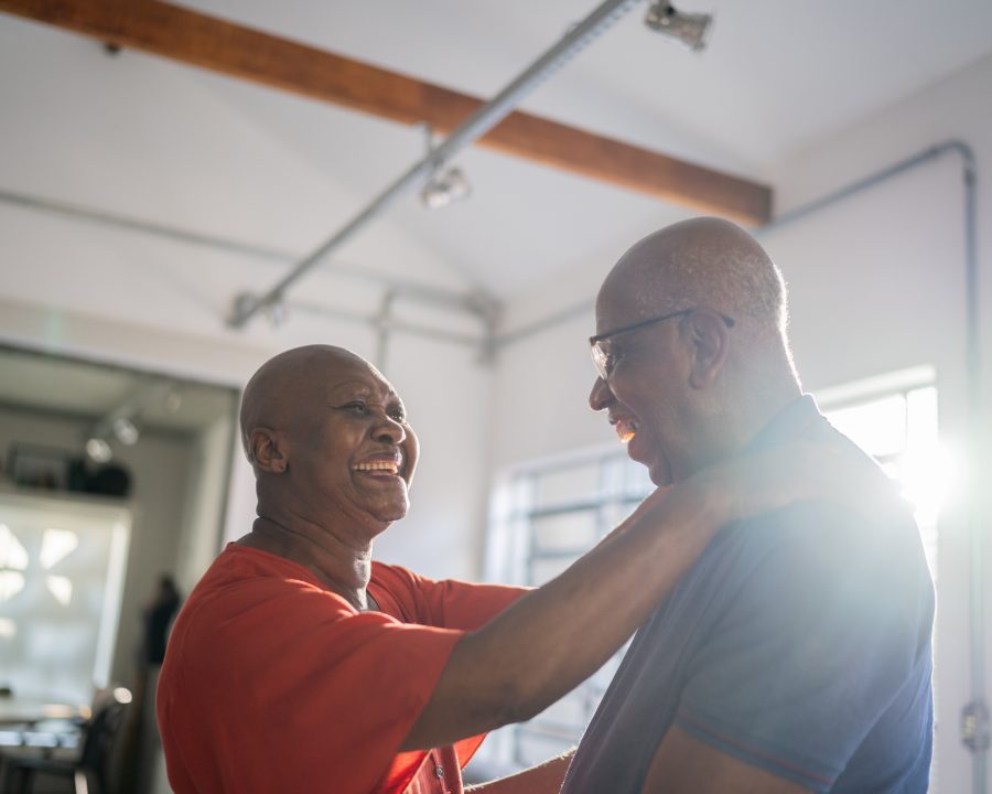 Senior couple dancing at home