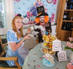 Lucy Buckle and Daniel Sabau toast with their tea cups at the Mad Hatter's Tea Party.