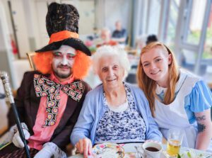 Staff and residents at the Mad Hatter's Tea Party.