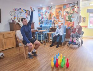 Cardinals in the Community member with a resident suring an exercise session.