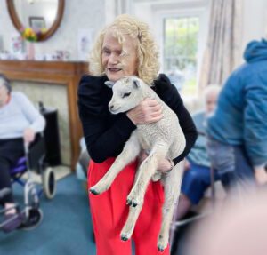 Holding a lamb.