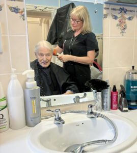 A Redcot resident during their hairdressing appointment.