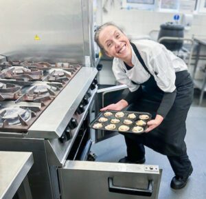 Chef putting the pies in the oven. 