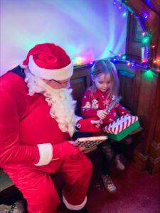 Santa Claus being visited in his grotto at last year's event. 