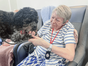 Winnie having cuddles with a resident. 