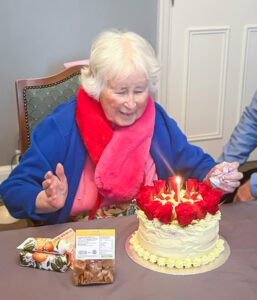 Betty celebrating on her Birthday with a birthday cake. 