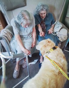 Two residents saying hello to Bailey. 