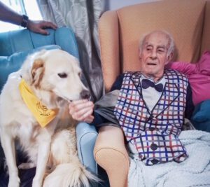 Visiting dog sat with a resident. 