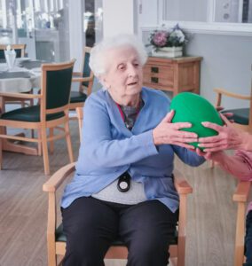 A resident being passed a ball. 