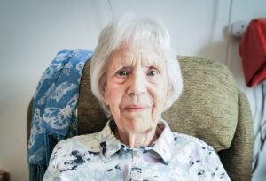 Essex care home resident Sylvia smiling at the camera.