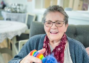 A Luton care home resident, Eileen, smiling at the camera.