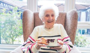2025 April Highlights: New Copford Place care home resident, Pat, enjoying a good cup of tea on National Tea Day