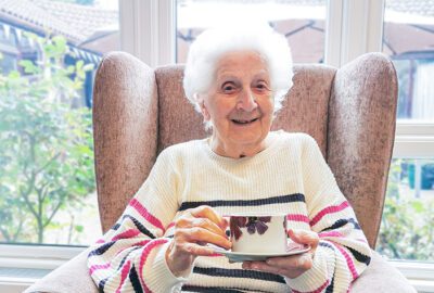 New Copford Place care home resident, Pat, enjoying a good cup of tea on National Tea Day