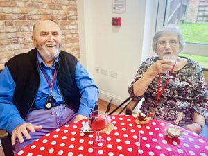 Residents toasting cocktails at the Jazz Cafe whilst smiling
