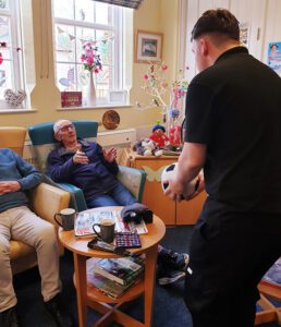 Keelan playing ball with a Kidderminster Day Care client whilst volunteering at the service.