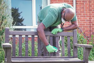 Access Volunteer David sanding a bench