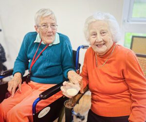 Two female residents smiling at the Jazz cafe.