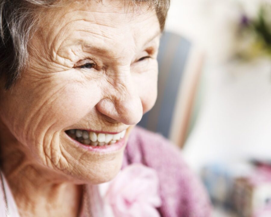 Older-woman-smiling-happy-close-up-space-to-right-landscape-LARGE-e1678804514729-1536x1023
